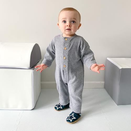 Baby standing up wearing Dotty Fish Navy Starry Night baby shoes 