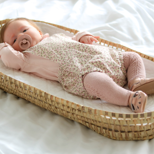 Young baby wearing rose gold t-bar soft leather baby shoes by Dotty Fish 