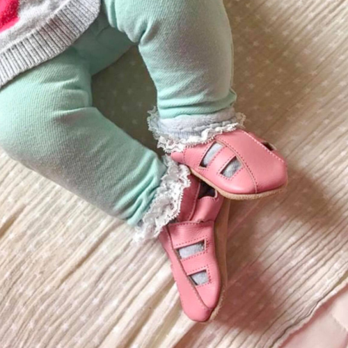 Baby girl wearing soft sole pink leather baby sandals from Dotty Fish