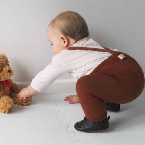 Toddler boy wearing brown leather first walking shoes with rubber sole from Dotty Fish 
