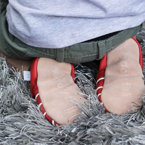 Toddler wearing red nautical anchors themed soft leather shoes with non-slip suede soles from Dotty Fish