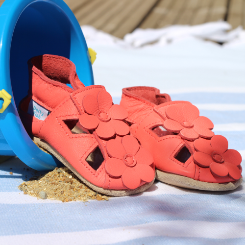 Coral flower sandals pictured with bucket and baby blanket