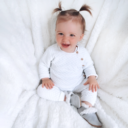 Little girl wearing soft grey suede slippers with warm fleece lining from Dotty Fish 