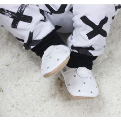 Tiny baby wearing white leather baby shoes with simple cut out star design by Dotty Fish 