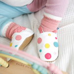 Toddler wearing White Spotty Dotty soft leather baby shoes by Dotty Fish